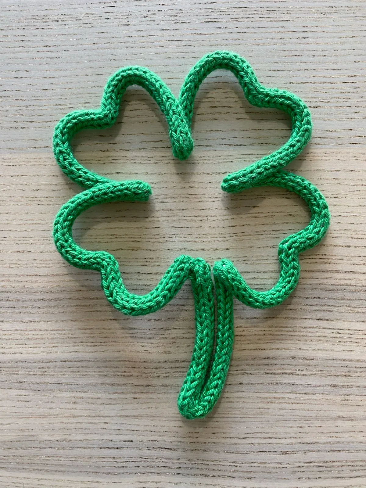 Lucky shamrock: A four-leaf clover knitted in fresh green.